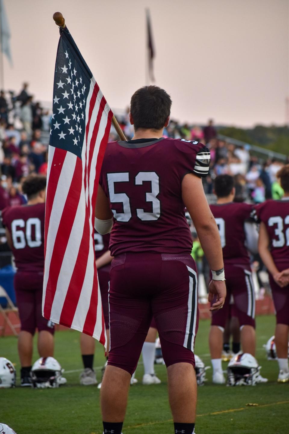Stroudsburg senior Anthony Liguori holds a U.S. flag during the Stroudsburg fight song prior to Friday's game against Northampton on Sept. 10, 2021.