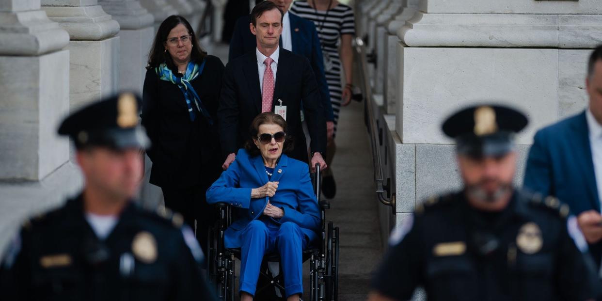 Sen. Dianne Feinstein, surrounded by staff and Capitol Police, leaves the Capitol on May 11, 2023.