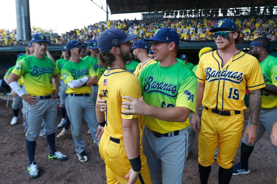 Savannah Bananas coach Tyler Gillum greets Bill LeRoy on the field before the start of the Banana Fest in May at Grayson Stadium.