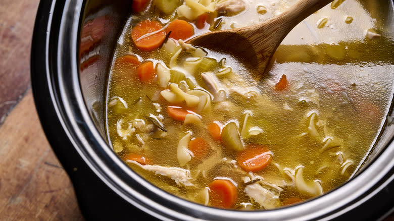 stirring soup in slow cooker