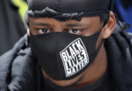 People gather in Manchester, England, Saturday June 6, 2020, to protest against the recent killing of George Floyd by police officers in Minneapolis, USA, that has led to protests in many countries and across the US. A US police officer has been charged with the death of George Floyd. (Danny Lawson/PA via AP)