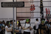 Protesters wear masks in Hong Kong, Friday, Oct. 18, 2019. Hong Kong pro-democracy protesters are donning cartoon/superheroes masks as they formed a human chain across the semiautonomous Chinese city, in defiance of a government ban on face coverings. (AP Photo/Mark Schiefelbein)