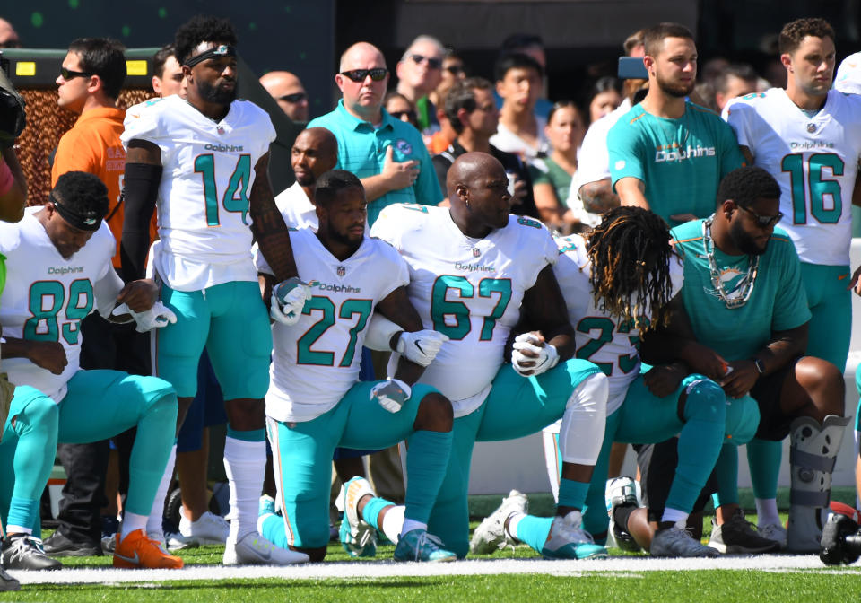 <p>Some of the Miami Dolphins take a knee during the anthem prior to the game against the New York Jets at MetLife Stadium. Mandatory Credit: Robert Deutsch-USA TODAY Sports </p>