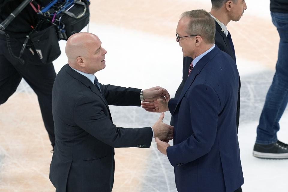 Boston Bruins head coach Jim Montgomery, left, talks with Florida Panthers head coach Paul Maurice, right, after the Panthers defeated the Bruins in Game 6 of an NHL hockey Stanley Cup second-round playoff series, Friday, May 17, 2024, in Boston. (AP Photo/Michael Dwyer)