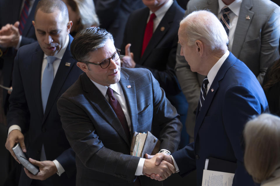 President Joe Biden, shakes hands with House Speaker Mike Johnson of La., joined at left by House Minority Leader Hakeem Jeffries, D-N.Y., at the conclusion of the National Prayer Breakfast, Thursday, Feb. 1, 2024, at the Capitol in Washington. (AP Photo/J. Scott Applewhite)