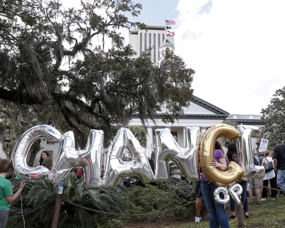 Supporters hold up balloons spelling out the word “change”