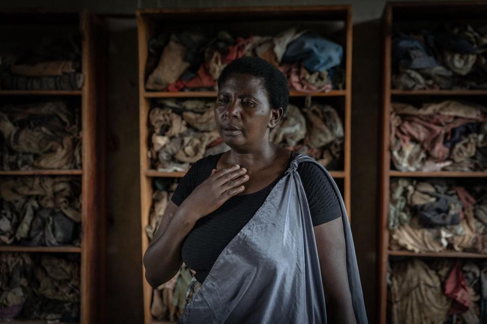 A survivor of the Rwandan genocide looks at clothes of genocide victims who were killed by Hutu militants in 1994. <a href="https://www.gettyimages.com/detail/news-photo/juliet-mukakabanda-a-survivor-that-will-testify-in-france-news-photo/1240477849?adppopup=true" rel="nofollow noopener" target="_blank" data-ylk="slk:Simon Wohlfahrt/AFP via Getty Images;elm:context_link;itc:0;sec:content-canvas" class="link ">Simon Wohlfahrt/AFP via Getty Images</a>