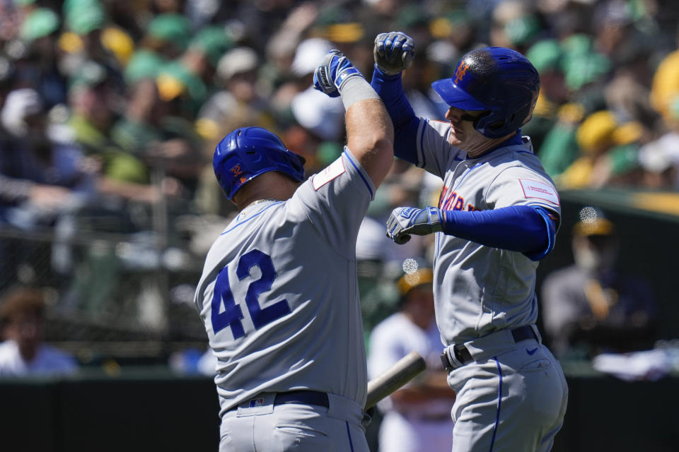 New York Mets' Mark Canha, right, celebrates with Daniel Vogelbach after hitting a solo home run against the Oakland Athletics during the seventh inning of a baseball game in Oakland, Calif., Saturday, April 15, 2023. (AP Photo/Godofredo A. Vásquez)
