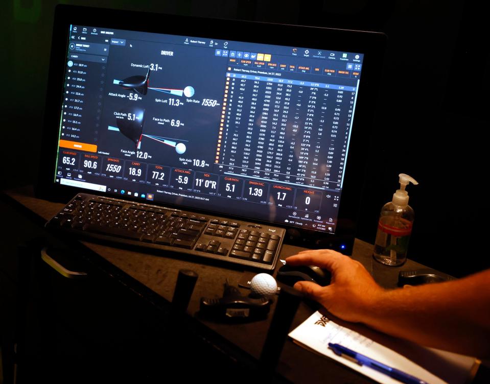 Mark Lahnala, 32, of South Lyon, who is a fitting specialist at PXG (Parsons Extreme Golf) in Troy, shows off ball speed velocity and many other factors in measuring the drive of a golf ball at the simulator during the one-day DAPCEP camp on July 27, 2022. Nineteen students from the metro Detroit school learned the science and engineering of golf from the clubs to ball striking.