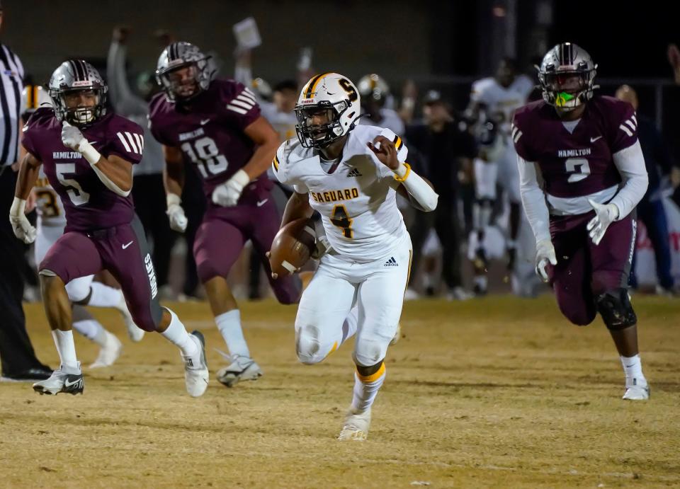 Saguaro quarterback Devon Dampier (4) finds running room against Hamilton in their Open division semi-final playoff game in Chandler Dec, 4, 2021. 