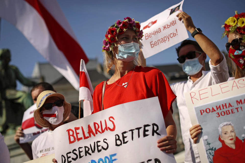 FILE - People shout slogans during a small protest against Belarusian President Alexander Lukashenko outside the European Parliament in Brussels, on Sept. 15, 2020. Belarusians will cast ballots Sunday in tightly controlled parliamentary and local elections that are set to cement an authoritarian leader's rule, despite calls for a boycott by an opposition leader who described the balloting as a "senseless farce." (AP Photo/Francisco Seco, File)