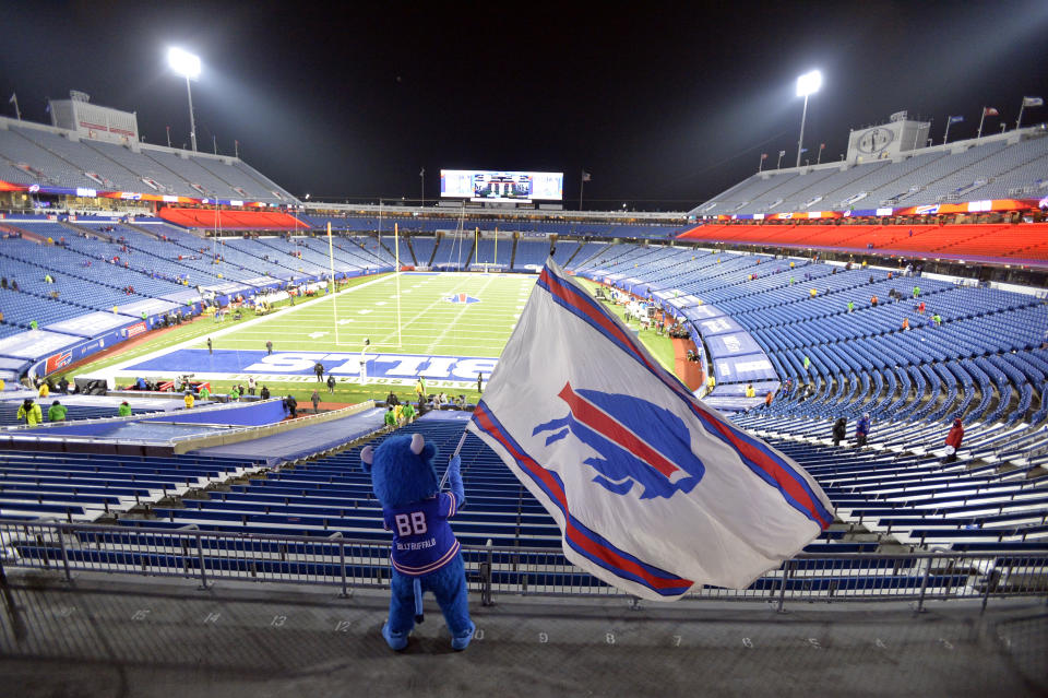 FILE - Buffalo Bills fans leave Bills Stadium as a mascot waves a flag after an NFL divisional round football game against the Baltimore Ravens on Saturday, Jan. 16, 2021, in Orchard Park, N.Y. An agreement that would commit hundreds of millions of dollars in taxpayer funds to build a new stadium for the Buffalo Bills is approaching completion, with New York Gov. Kathy Hochul confident a deal will be struck before the end of the month. Hochul on Friday, March 4, 2022, said many of the issues have been resolved, with discussions now focusing on what she called “the nuts and bolts,” including the length of the lease to ensure the franchise’s long-term presence in the Buffalo region. (AP Photo/Adrian Kraus, File)