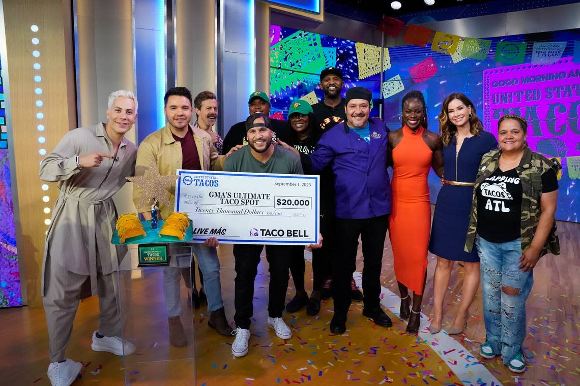 Nuno Grullon of Uptown 66 Mexican restaurant holds the $20,000 check he won in the “Good Morning America” competition for best tacos in the United States.