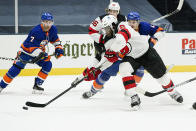 New Jersey Devils' P.K. Subban (76) fights for control of t he puck with New York Islanders' Mathew Barzal (13) and Jordan Eberle (7) during the second period of an NHL hockey game Thursday, Jan. 21, 2021, in Uniondale, N.Y. (AP Photo/Frank Franklin II)