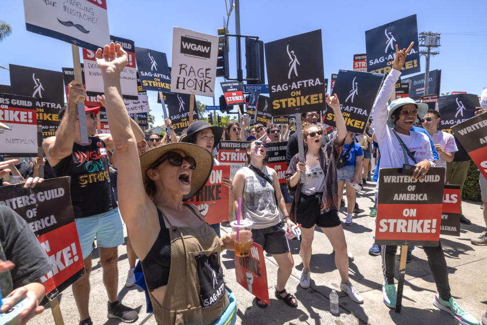 LOS ANGELES, CALIFORNIA - JULY 14: Members of the Hollywood actors SAG-AFTRA union walk a picket line with screen writers outside of Paramount Studios on the first day of the actors’ strike which piles on top of the Hollywood writers WGA union strike, now in the 11th week, on July 14, 2023 in Los Angeles, California. The actors union has not gone on strike since 1980 and a "double strike" involving both the actors and writers unions at the same time has not occurred since1960. The simultaneous walkouts by actors and writers brings film and television productions to a halt and is predicted to have widespread major economic impact on the industry, both locally and internationally, as well as on many businesses that are directly or indirectly rely on it.   (Photo by David McNew/Getty Images)