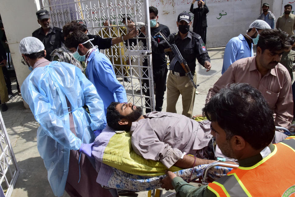 Paramedics and volunteers transport an injured victim of a bomb explosion upon arrival at a hospital, in Quetta, Pakistan, Friday, Sept. 29, 2023. A powerful bomb exploded at a rally celebrating the birthday of Islam's Prophet Muhammad in southwest Pakistan on Friday, killing multiple people and wounding dozens of others, police and a government official said. (AP Photo/Arshad Butt)