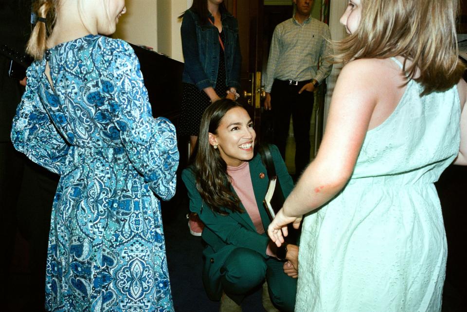 AOC greets young relatives of the chief of staff of Rep. Earl Blumenauer (D-OR). “Make sure you keep this experience in mind,” she says.