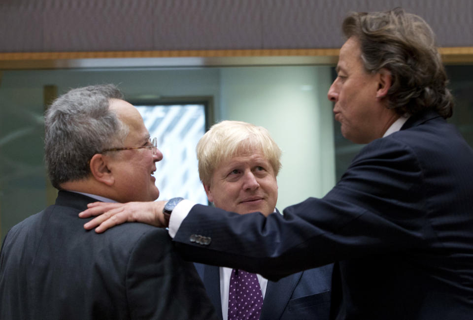 British Foreign Minister Boris Johnson, center, speaks with Greek Foreign Minister Nikos Kotzias, left, and Dutch Foreign Minister Bert Koenders, right, during a meeting of EU foreign ministers at the EU Council building on Monday, Feb. 6, 2017. (AP Photo/Virginia Mayo)