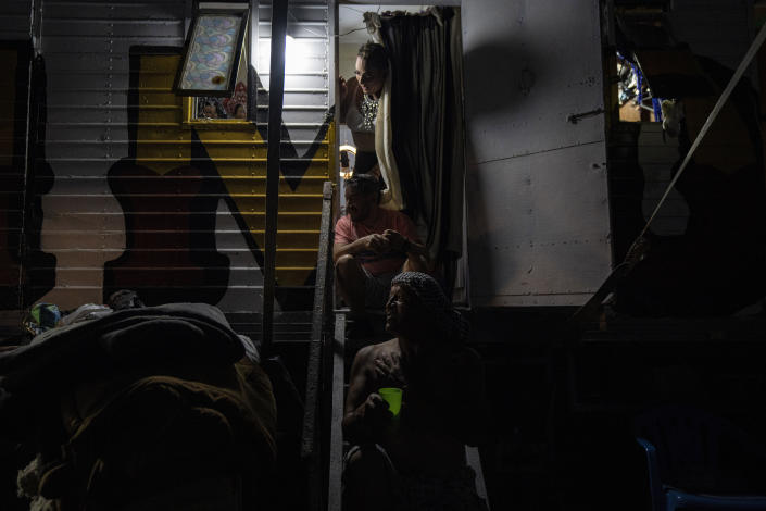 Timoteo Circus performer Adolfo Salas looks out from his trailer as he begins his transformation to Prince Angel for the evening show, on the outskirts of Santiago, Chile, Saturday, Dec. 10, 2022. The Timoteo Circus is a show that has fought prejudice and discrimination against Chile’s LGBTQ community for more than a half century(AP Photo/Esteban Felix)