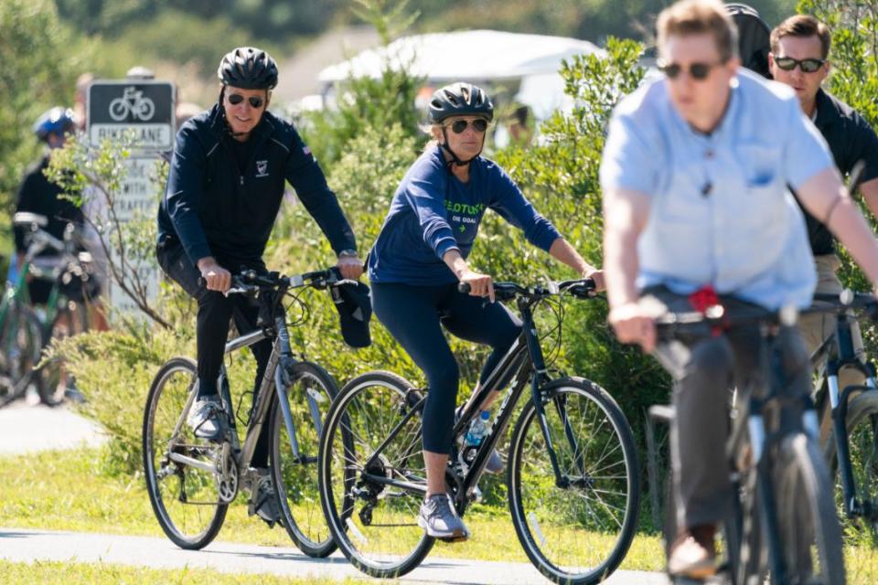 President Joe Biden and first lady Jill Biden ride their bikes on a trail at Gordons Pond in Rehoboth Beach, Del., Sunday, Sept. 19, 2021. Biden is spending the weekend at his Rehoboth Beach home. - Credit: AP