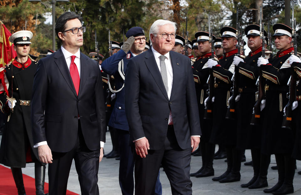 German President Frank-Walter Steinmeier, center, accompanied by his North Macedonia's counterpart Stevo Pendarovski, left, reviews an honour guard upon his arrival at the presidential palace in Skopje, North Macedonia, on Tuesday, Nov. 29, 2022. German President Steinmeier is on a two-day official visit to North Macedonia. (AP Photo/Boris Grdanoski)