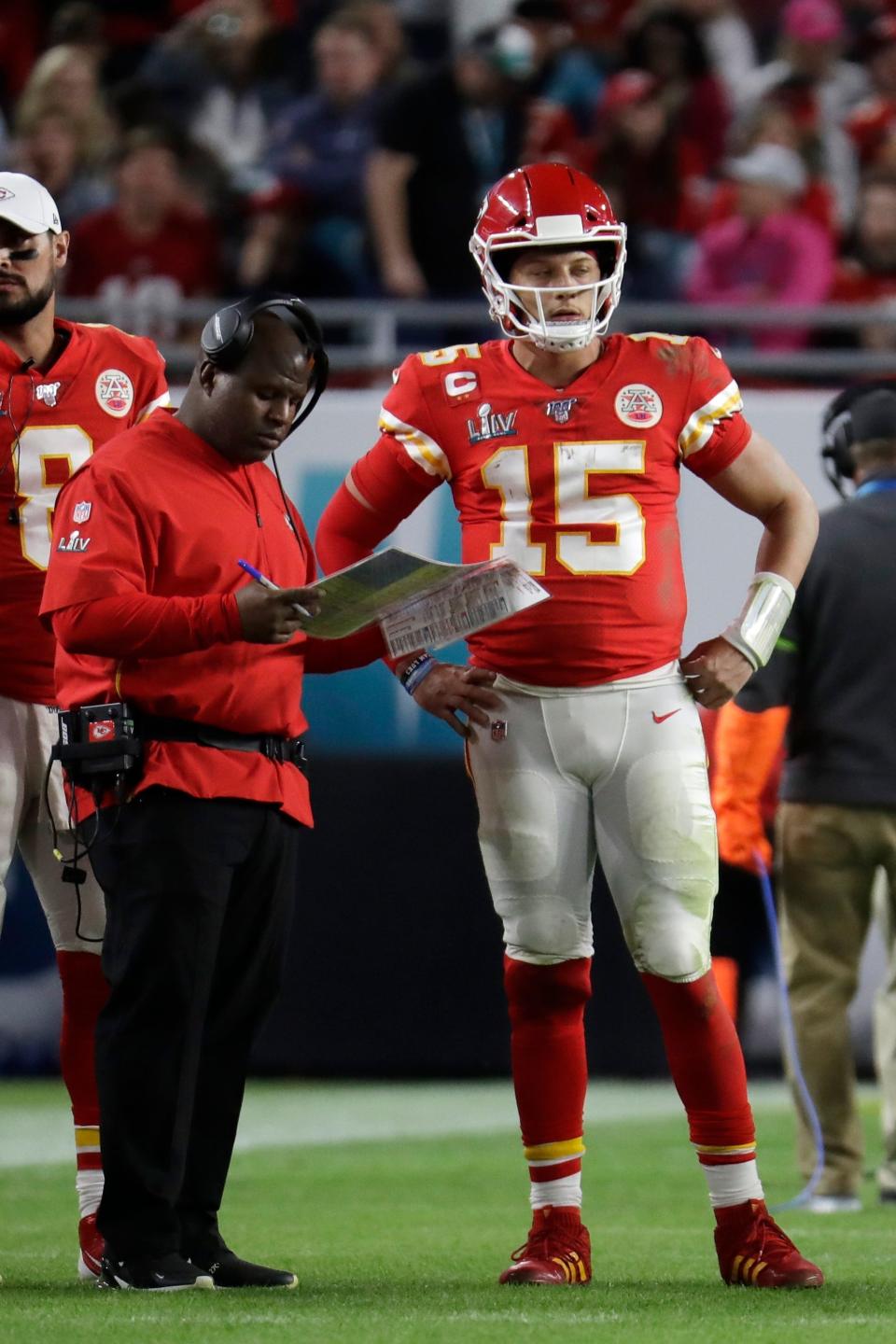 Kansas City Chiefs quarterback Patrick Mahomes (15) speaks with offensive coordinator Eric Bieniemy during the second half of the NFL Super Bowl 54 football game against the San Francisco 49ers, Sunday, Feb. 2, 2020, in Miami Gardens, Fla. (AP Photo/Lynne Sladky)
