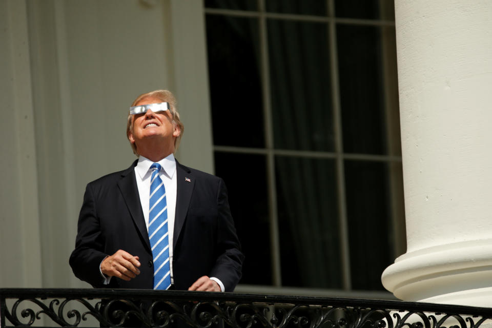 President Donald Trump watches from the Truman Balcony.&nbsp;