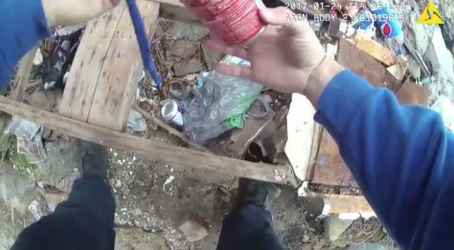 A police officer has been filmed by his own body camera allegedly planting drugs inside a soup can. Photo: Baltimore Police Department
