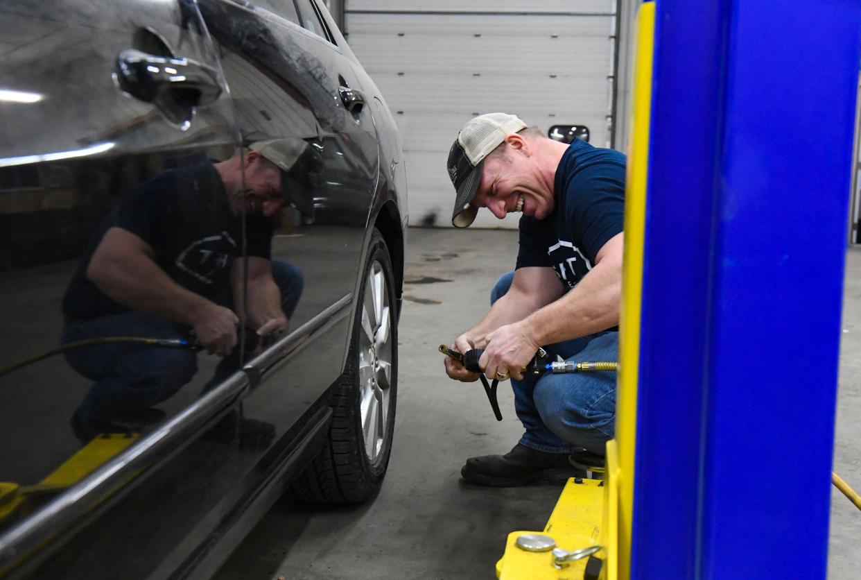 SHIFT Garage volunteer Chad Huston checks the tire pressure on a donated car on Wednesday, January 12, 2022, in Sioux Falls.