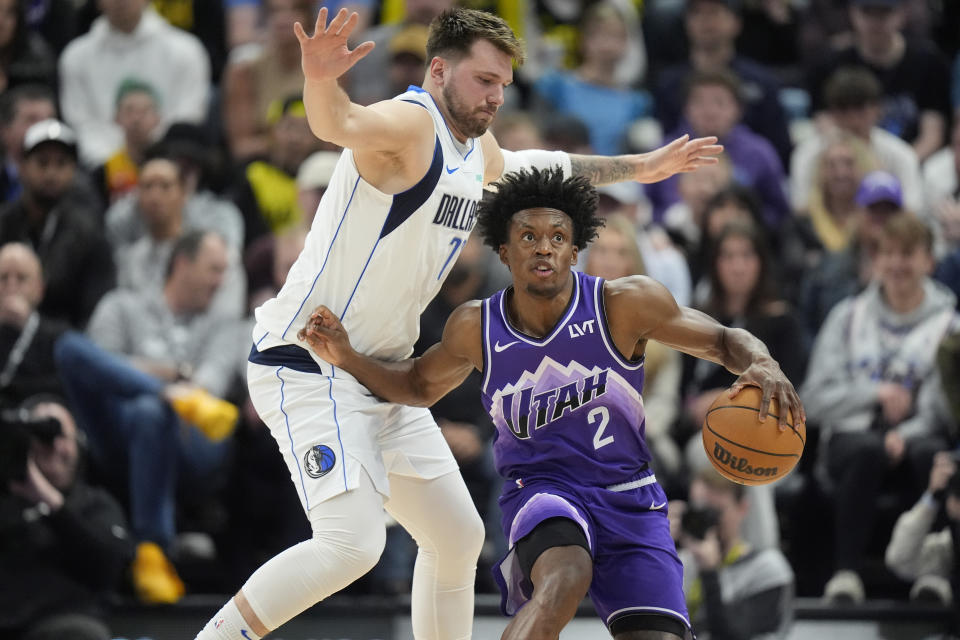 Dallas Mavericks guard Luka Doncic, left, guards Utah Jazz guard Collin Sexton (2) during the first half of an NBA basketball game Monday, March 25, 2024, in Salt Lake City. (AP Photo/Rick Bowmer)