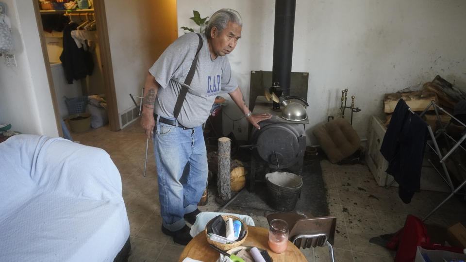 Arthur John, 82, a retired trapper, is photographed at his home Thursday, Sept. 23, 2021, in Tanacross, Alaska. Arthur John spent nearly 30 days at in the hospital with COVID, dropping about 40 pounds during his stay. He's recovered, but COVID of robbed him of the lifestyle he so enjoyed, such as using a chainsaw to chop enough wood to heat their house through winter. "It makes me weak and can't work like before," the village elder said. "There's so much it took off me and I just wish for working."(AP Photo/Rick Bowmer)