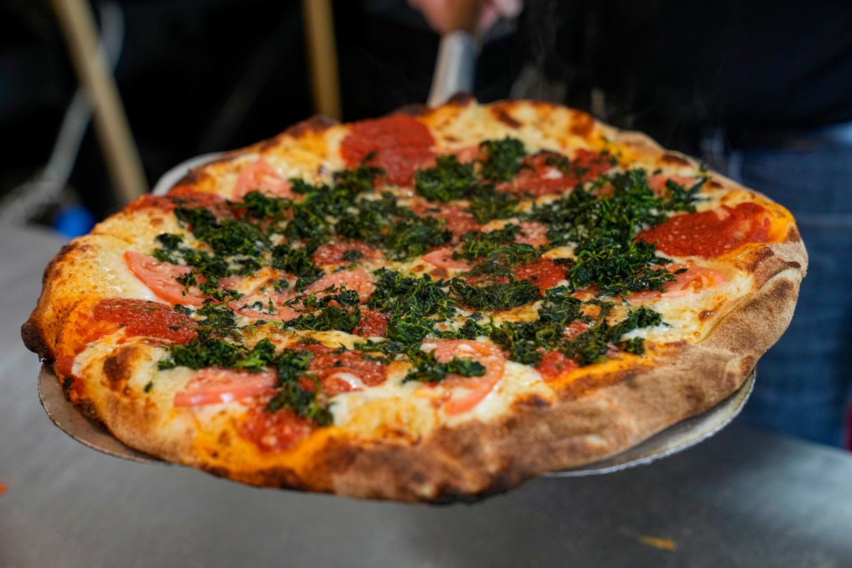 A tomato and spinach pizza from Strong’s Brick Oven Pizzeria in Newport.