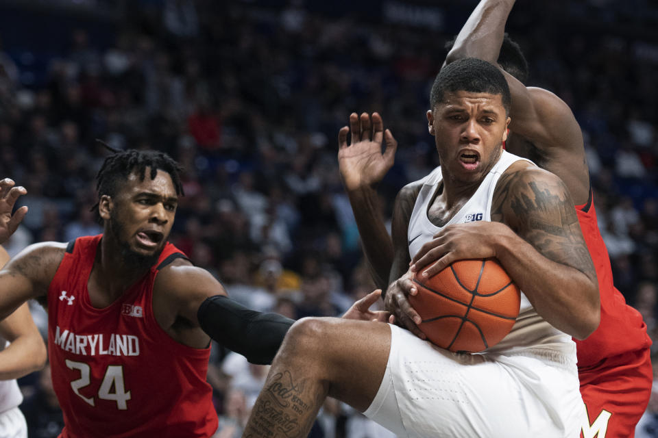 Penn State guard Myles Dread, right, beats Maryland forward Donta Scott (24) to a rebound in the first half of an NCAA college basketball game in State College, Pa., on Tuesday, Dec. 10, 2019. (AP Photo/Barry Reeger)