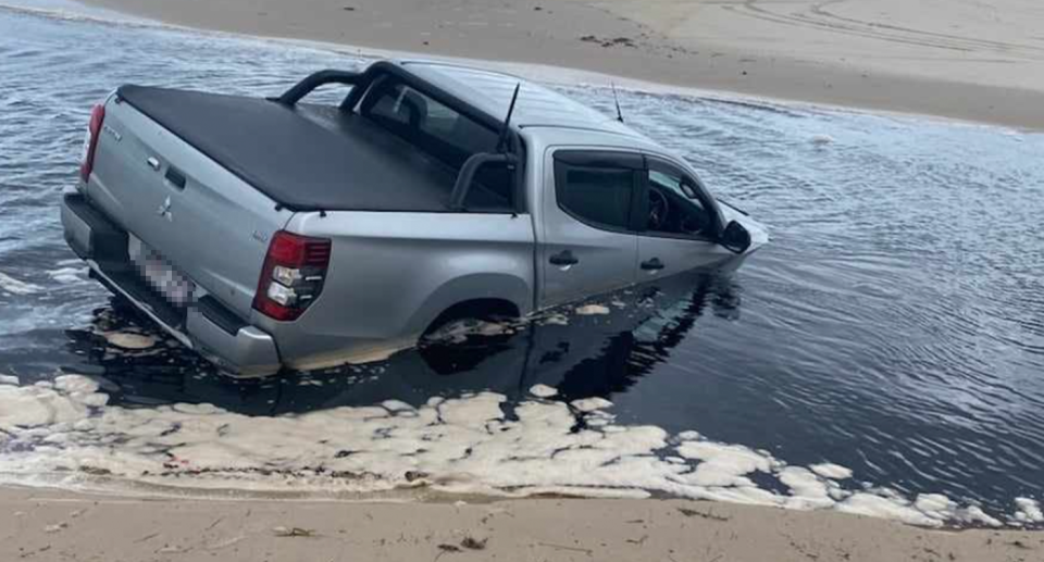 A ute submerged in seawater on Bribie Island. 