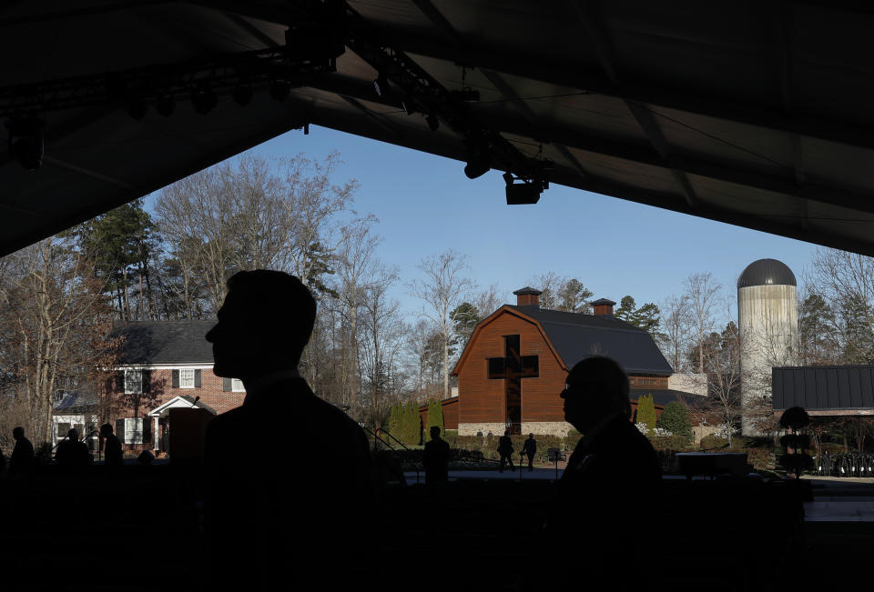<p>The Billy Graham Library is seen in the background as people are silhouetted as they arrive for the funeral service for the late U.S. evangelist Billy Graham in Charlotte, N.C., March 2, 2018. (Photo: Leah Millis/Reuters) </p>