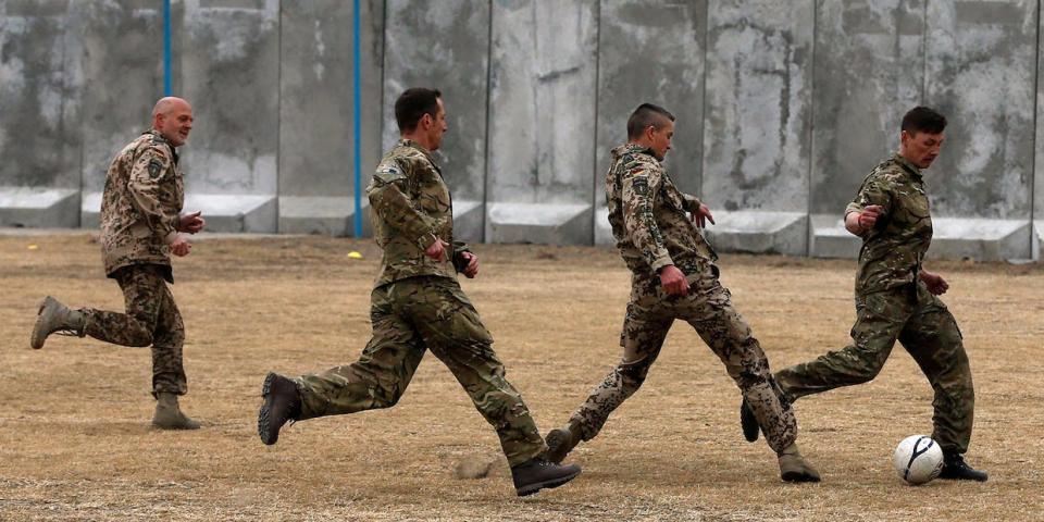British and German troops play soccer, Afghanistan