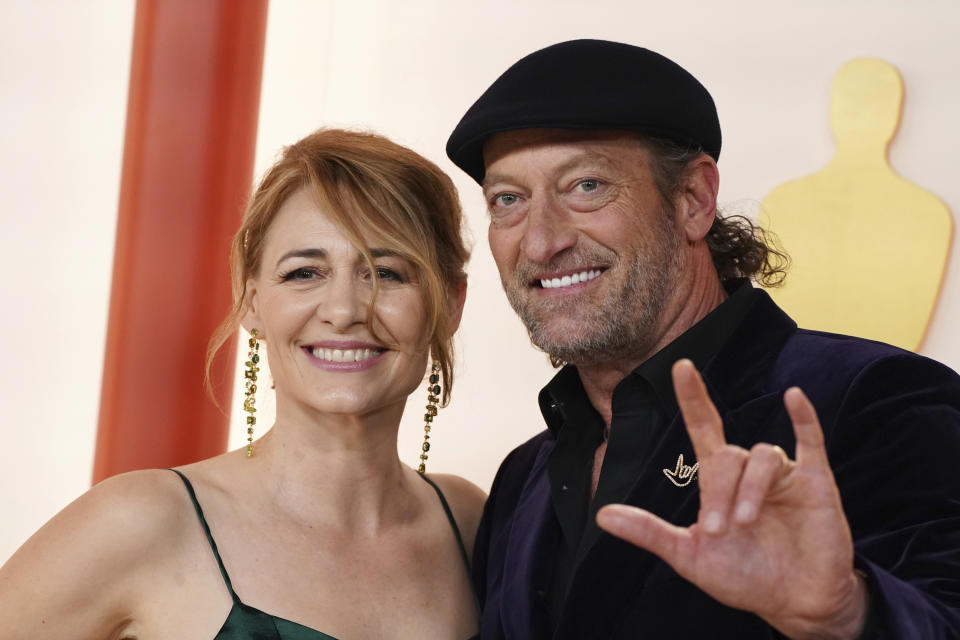 Deanne Bray, left, and Troy Kotsur, signing 'I love you', arrive at the Oscars on Sunday, March 12, 2023, at the Dolby Theatre in Los Angeles. (Photo by Jordan Strauss/Invision/AP)