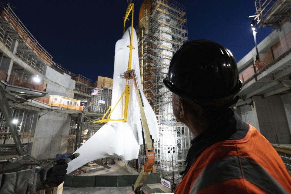 Jeffrey Rudolph President and CEO of California Science Center looks at the Space Shuttle Endeavour after it was put in place at the site of the future Samuel Oschin Air and Space Center on Tuesday, Jan. 30, 2024, in Los Angeles. NASA's retired Space Shuttle Endeavour was carefully hoisted late Monday to be mated to a huge external fuel tank and its two solid rocket boosters at a Los Angeles museum where it will be uniquely displayed as if it is about to blast off. (AP Photo/Richard Vogel)