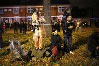 LEICESTER, UNITED KINGDOM - NOVEMBER 13: Families and locals gather to watch fireworks during the Hindu festival of Diwali on November 13, 2012 in Leicester, United Kingdom. Up to 35,000 people attended the Diwali festival of light in Leicester's Golden Mile in the heart of the city's asian community. The festival is an opportunity for Hindus to honour Lakshmi, the goddess of wealth and other gods. Leicester's celebrations are one of the biggest in the world outside India. Sikhs and Jains also celebrate Diwali. (Photo by Christopher Furlong/Getty Images)