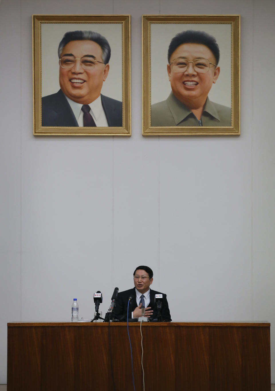 Kim Jung Wook, a South Korean Baptist missionary speaks under the portrait of late leaders Kim Il Sung and Kim Jong Il during a news conference in Pyongyang, North Korea, Thursday, Feb. 27, 2014. Kim who was arrested more than four months ago for allegedly trying to establish underground Christian churches in North Korea told reporters Thursday he is sorry for his ``anti-state’’ crimes and appealed to North Korean authorities to show him mercy by releasing him from their custody. (AP Photo/Vincent Yu)