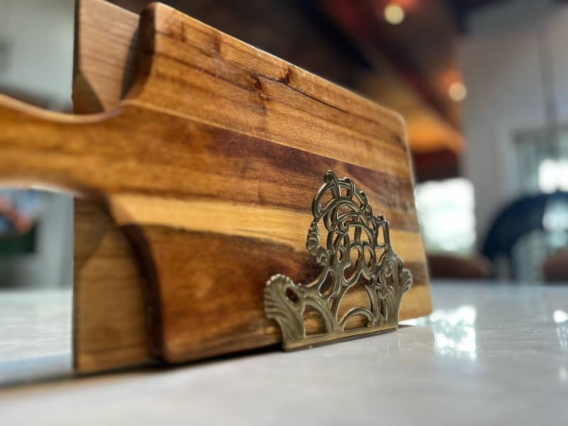 Vintage napkin holder holding wooden cutting boards.