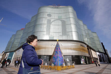 A woman walks past an Intime Lotte Department Store in downtown Beijing, China January 10, 2017. REUTERS/Jason Lee