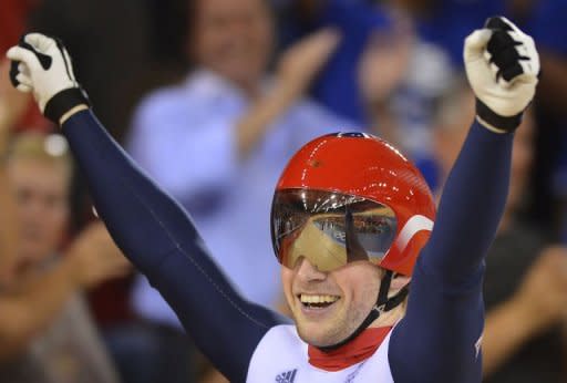 Britain's Jason Kenny celebrates after crossing the finish line ahead of France's Gregory Bauge to win the gold medal in the London 2012 Olympic Games men's sprint final cycling event at the Velodrome in the Olympic Park in East London