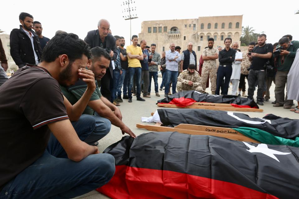 Mourners gather for funeral prayers for fighters killed by warplanes of Field Marshal Khalifa Hifter's forces, Wednesday, April 24, 2019 in Tripoli, Libya. A top Russian diplomat has called on the self-styled Libyan National Army to cease fire and stop its advance on the Libyan capital.(AP Photo/Hazem Ahmed)