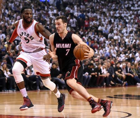 Miami Heat guard Goran Dragic (7) dribbles the ball past Toronto Raptors forward DeMarre Carroll (5) in game two of the second round of the NBA Playoffs at Air Canada Centre. The Raptors won 96-92. Mandlatory Credit: Dan Hamilton-USA TODAY Sports