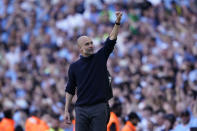 Manchester City's head coach Pep Guardiola celebrates at the end of the English Premier League soccer match between Manchester City and West Ham United at the Etihad Stadium in Manchester, England, Sunday, May 19, 2024. Manchester City clinched the English Premier League on Sunday after beating West Ham in their last match of the season. (AP Photo/Dave Thompson)