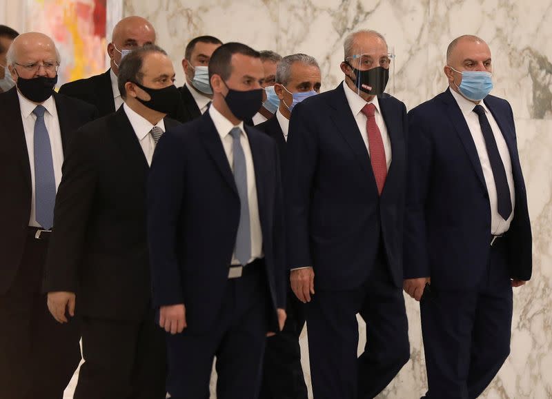 Lebanon's parliament speaker Nabih Berri wears a face mask as he walks at the presidential palace in Baabda