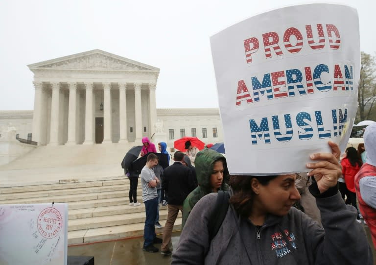 People protest outside the US Supreme Court ahead of a hearing on President Donald Trump's ban on travelers from several Muslim-majority countries