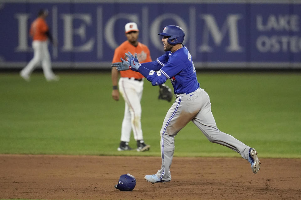 George Springer, bateador designado de los Azulejos de Toronto, festeja luego de conectar un jonrón de dos carreras en el primer juego de una doble tanda, realizada el sábado 11 de septiembre de 2021 (AP Foto/Julio Cortez)