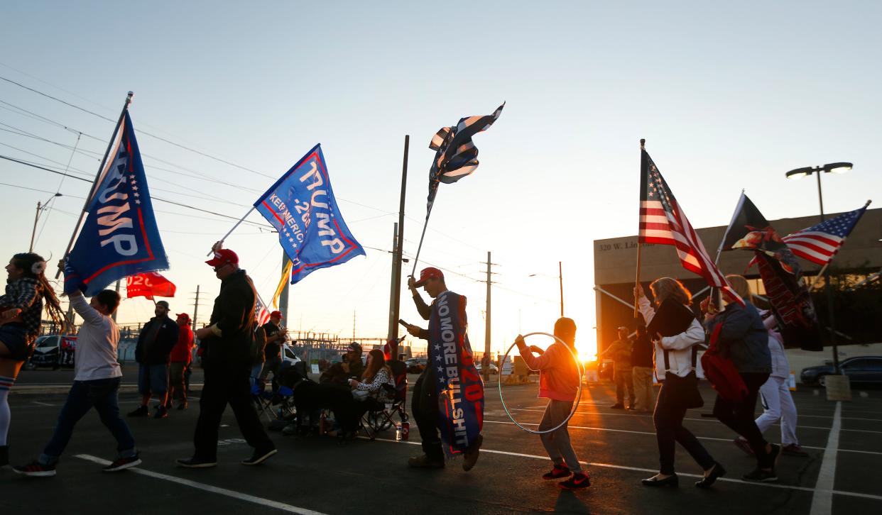 Protesters dance in a 'Trump Train' to the song YMCA during a "Stop the Steal" and "Count the Vote" protest at the Maricopa County Tabulation and Election Center in Phoenix, Ariz. on Nov. 9, 2020. 